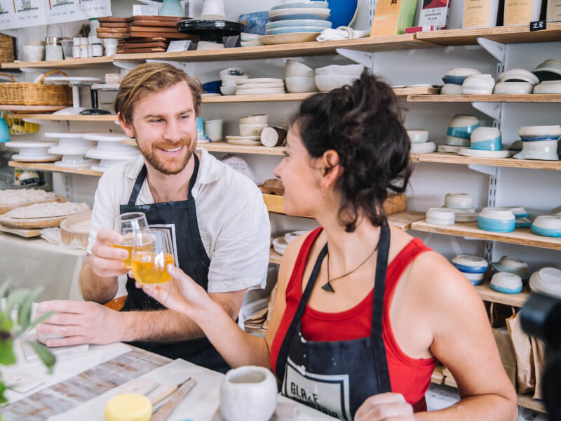 Man and woman having a drink in a pottery class